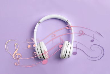Image of Staff with music notes and treble clef flowing over white headphones on lavender background, top view
