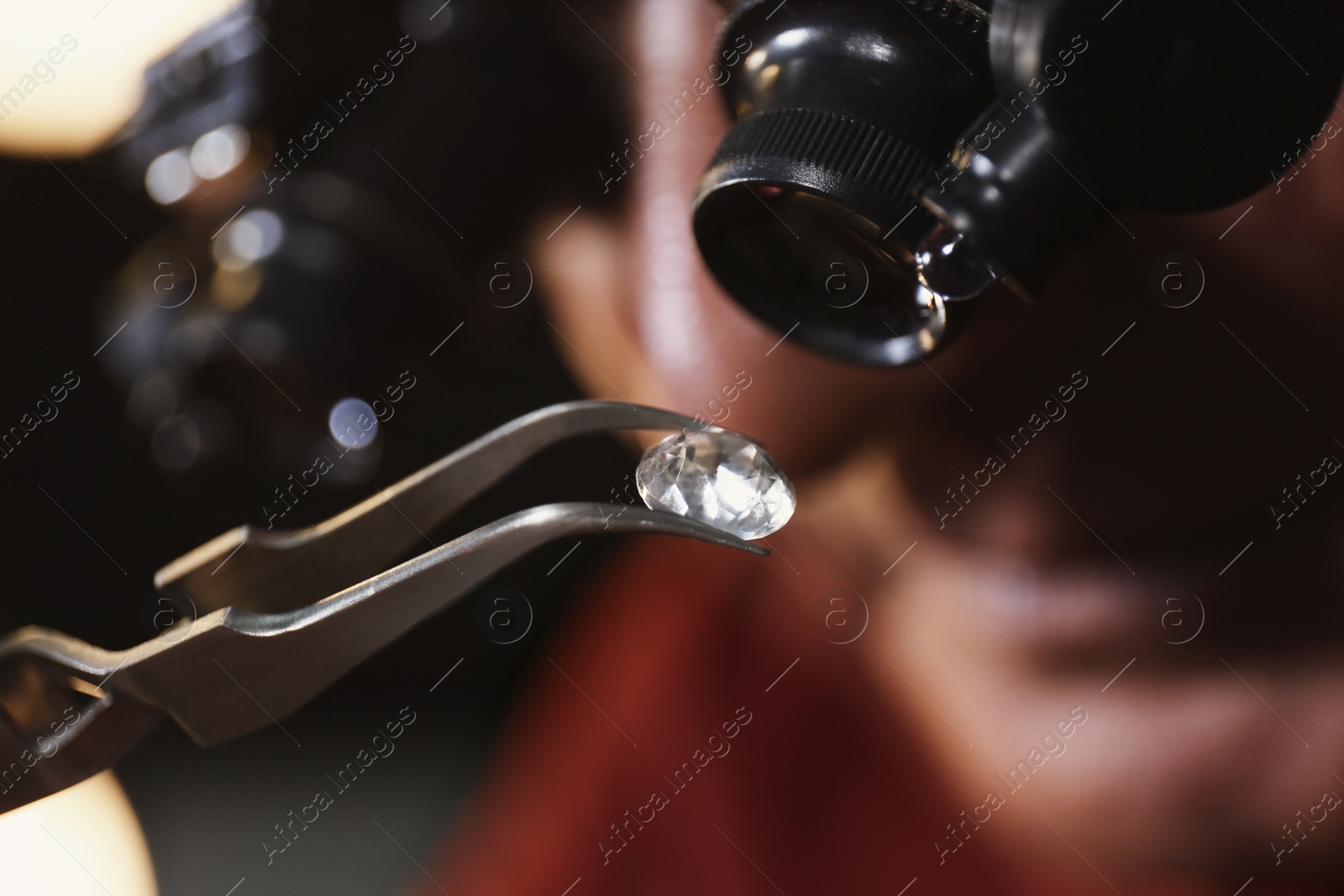 Photo of Professional jeweler evaluating beautiful gemstone, closeup view