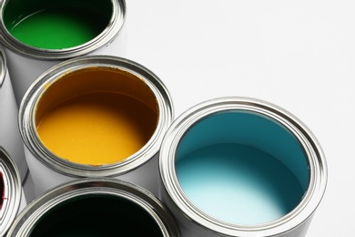 Many open paint cans on white background