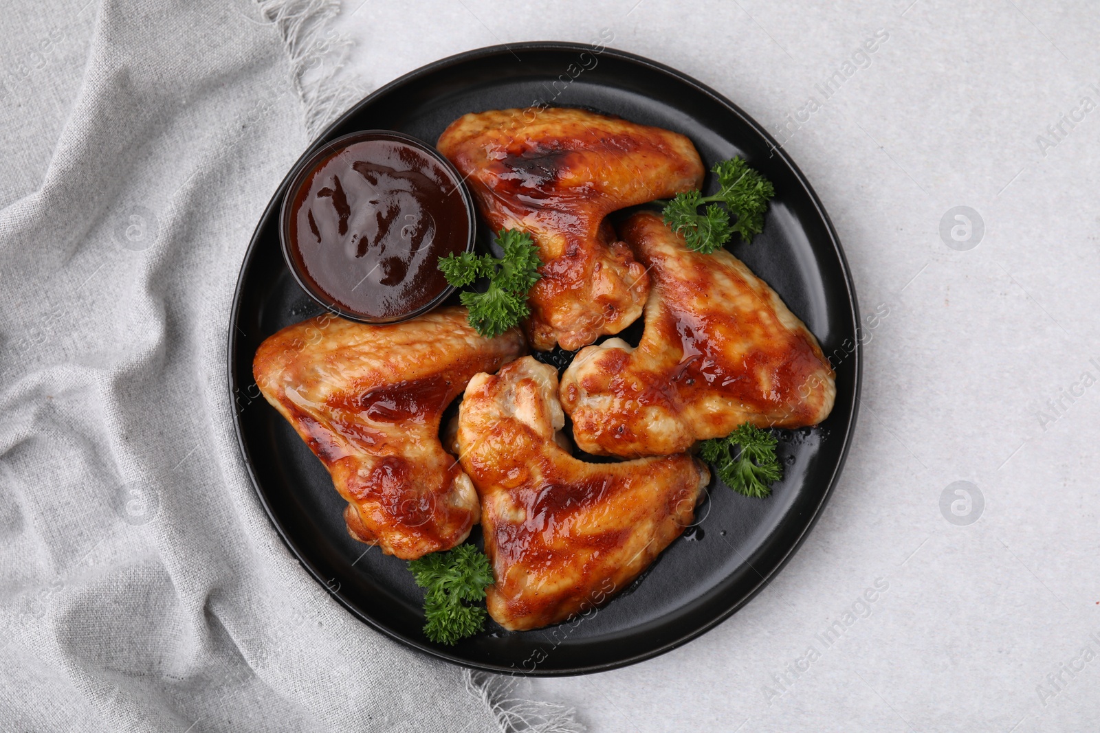 Photo of Fresh marinade and chicken wings on light table, top view