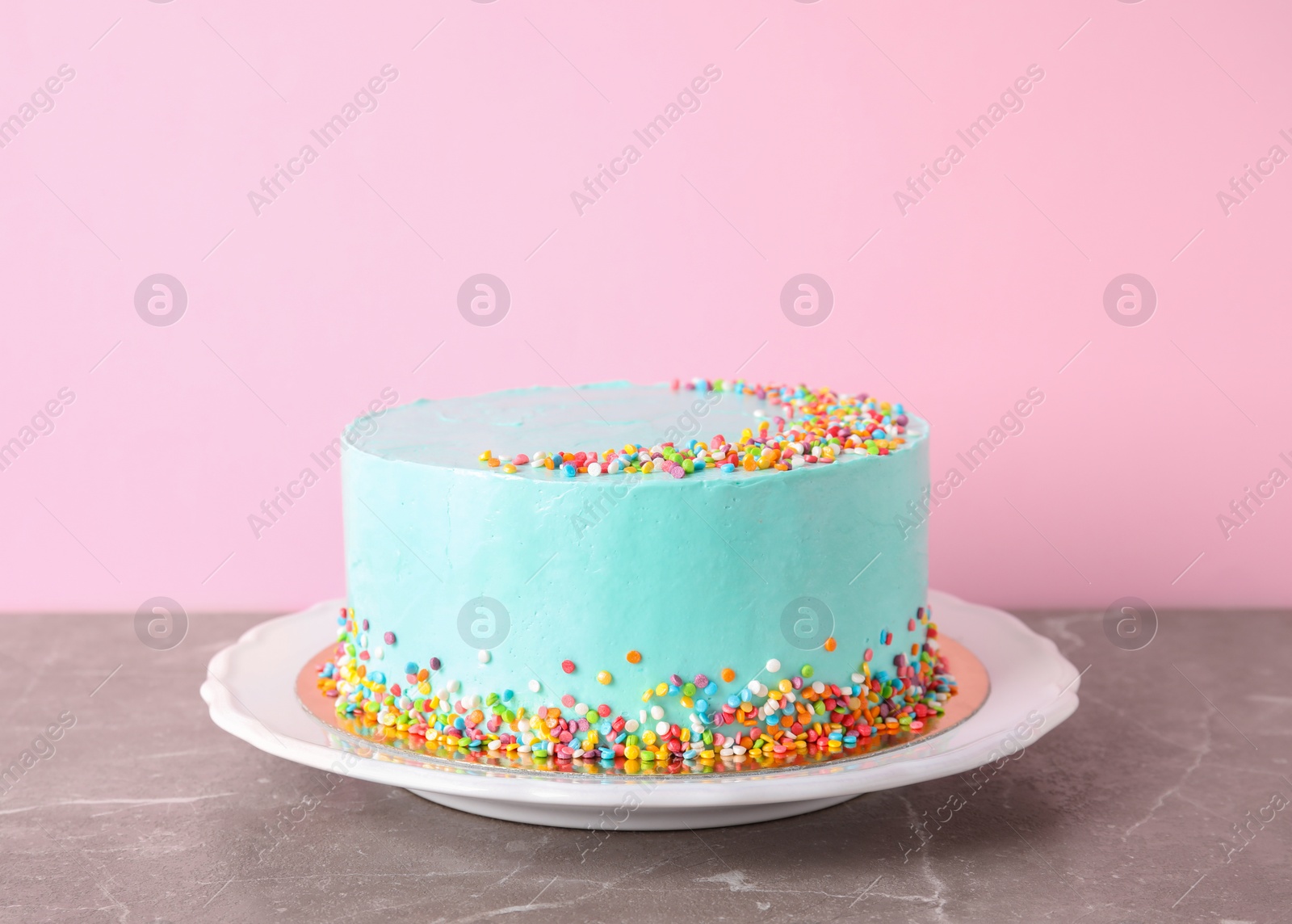 Photo of Plate with fresh delicious birthday cake on table against color background