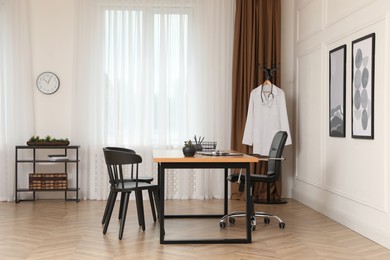 Modern medical office interior with doctor's workplace and chairs