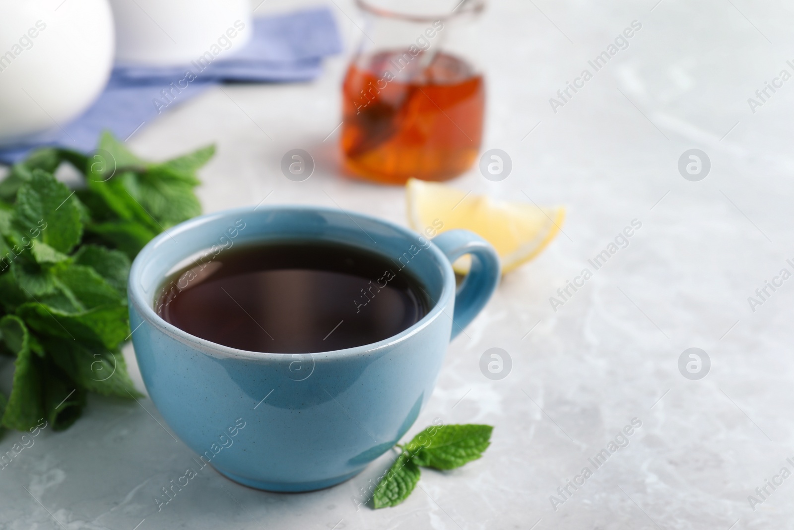 Photo of Fresh tea with mint on light table