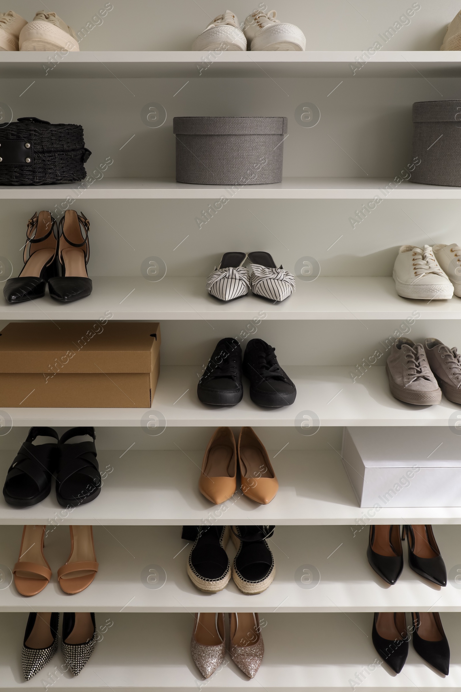 Photo of Storage rack with stylish women's shoes and accessories