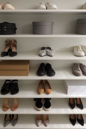 Photo of Storage rack with stylish women's shoes and accessories