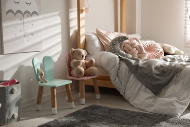 Photo of Cute chairs with bunny ears in children's bedroom interior