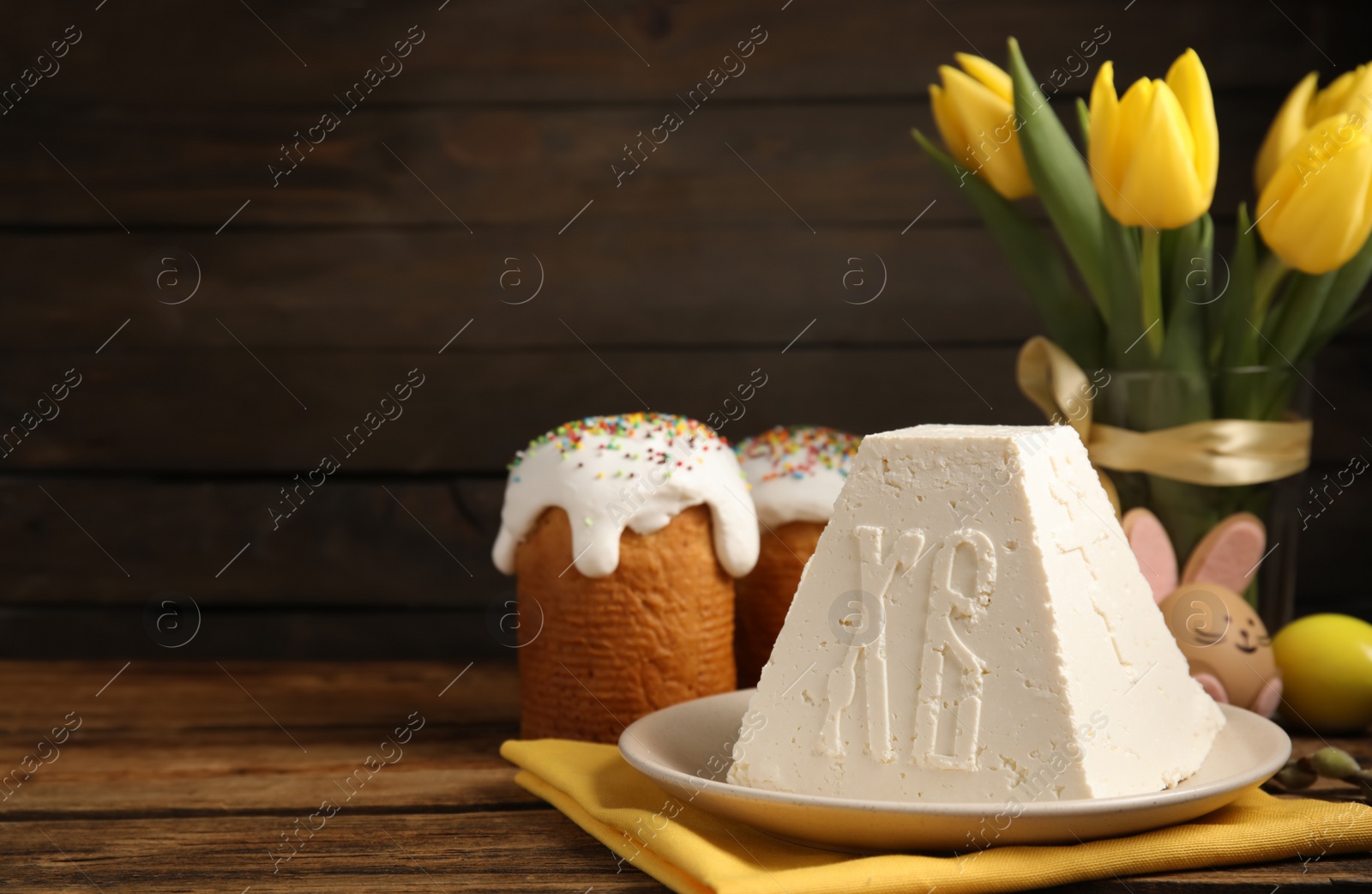 Photo of Traditional cottage cheese Easter paskha on wooden table, space for text