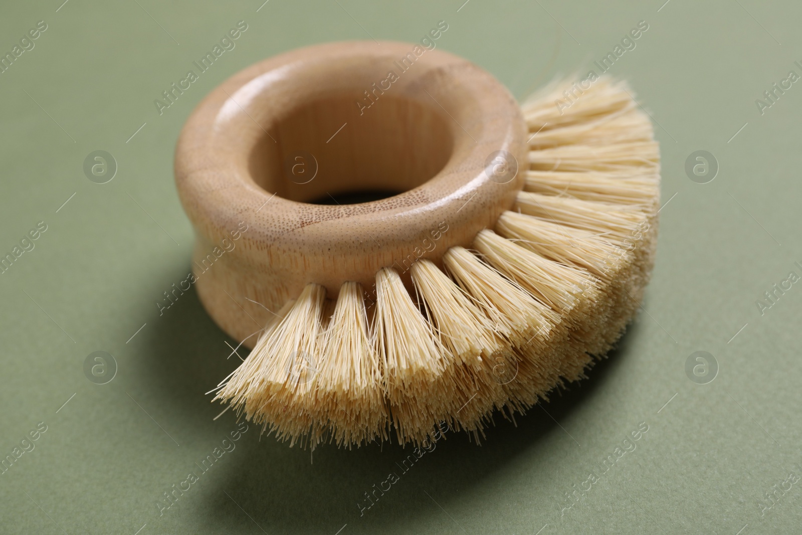 Photo of Cleaning brush on green background, closeup view