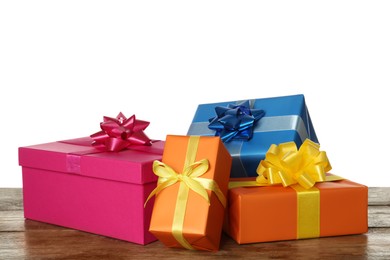 Colorful gift boxes on wooden table against white background