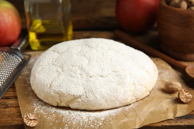 Photo of Raw dough for pastry on wooden table, closeup