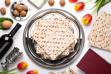 Photo of Flat lay composition with symbolic Pesach (Passover Seder) items on white wooden table