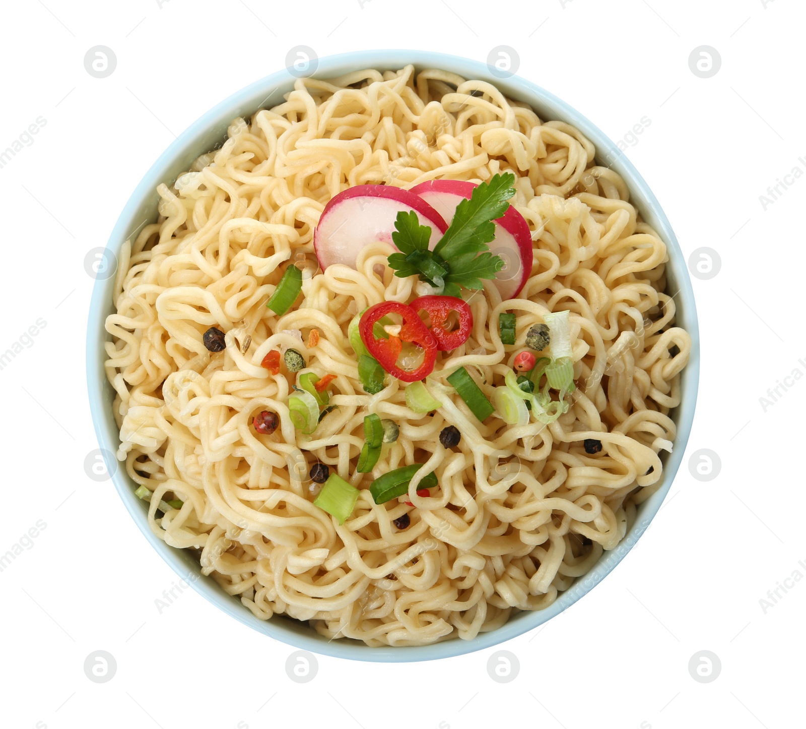 Photo of Tasty instant noodles with vegetables in bowl isolated on white, top view