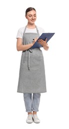 Beautiful young woman in clean apron with clipboard on white background