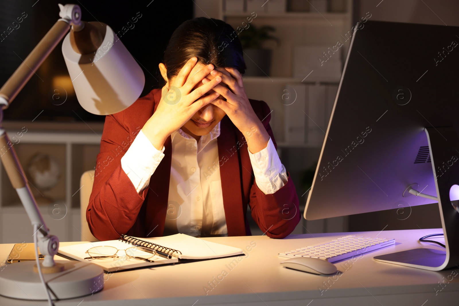 Photo of Tired overworked businesswoman at table in office