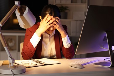 Photo of Tired overworked businesswoman at table in office