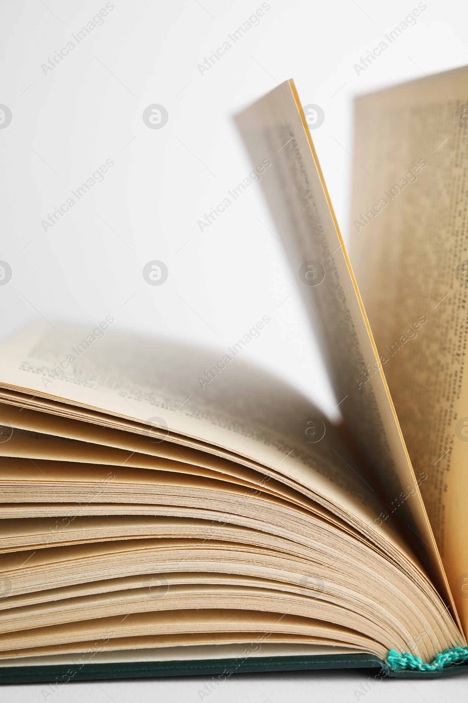 Photo of Closeup view of open book on white background