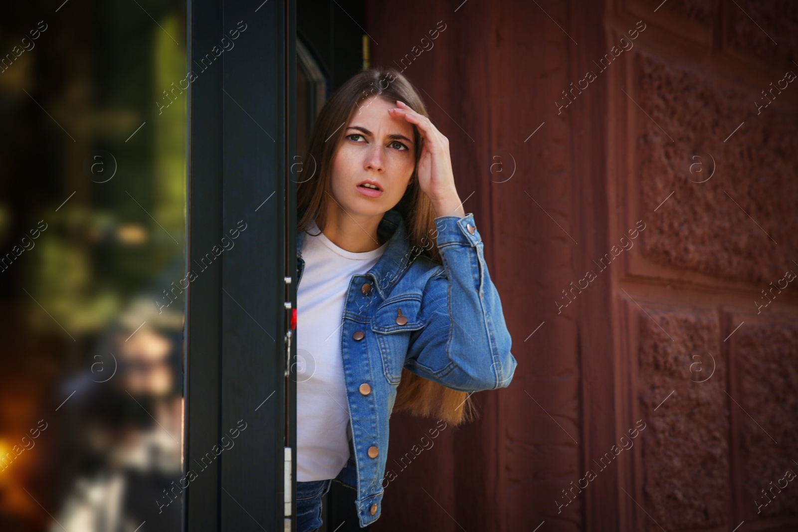 Photo of Jealous woman spying on ex boyfriend outdoors