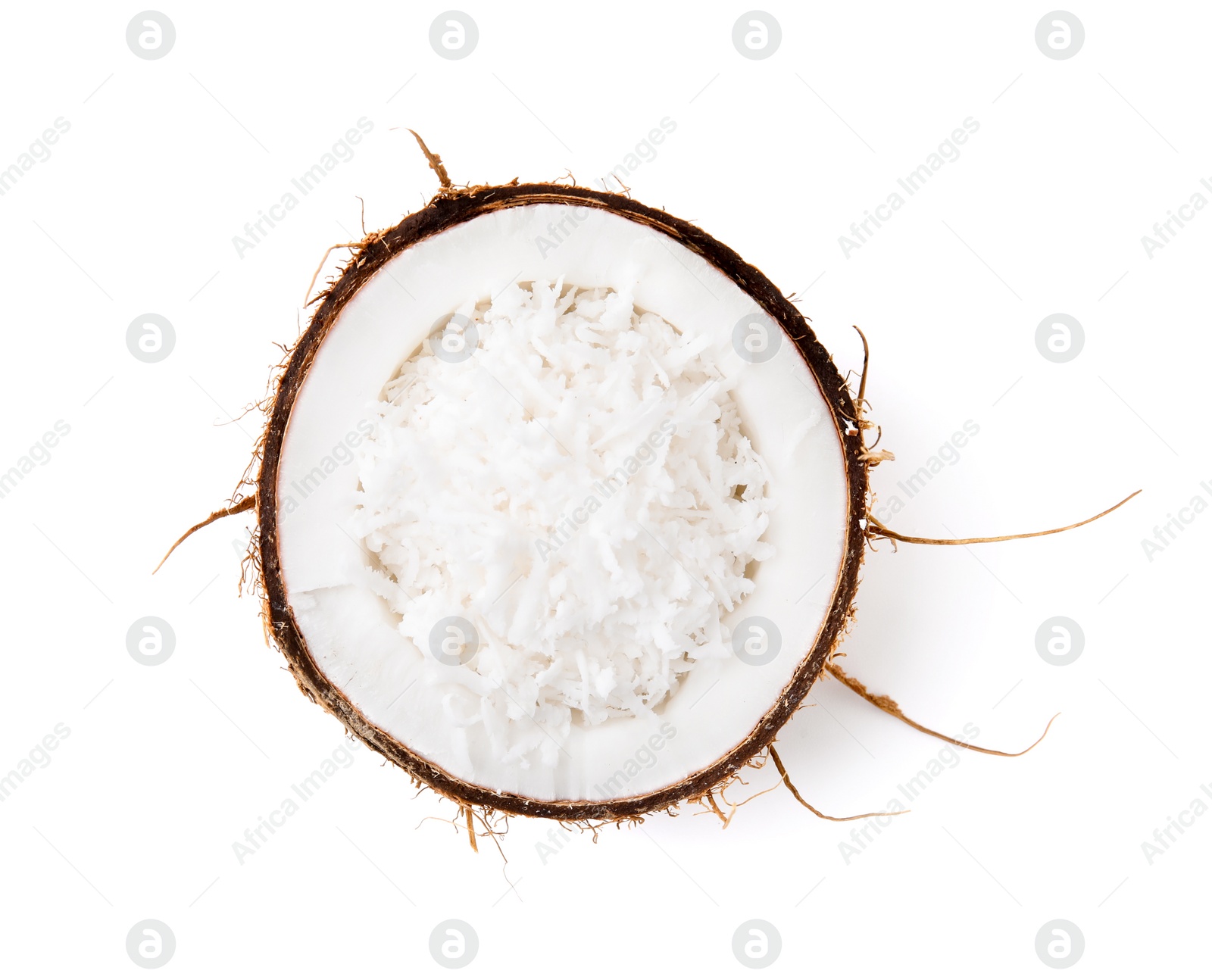 Photo of Coconut flakes in nut shell isolated on white, top view