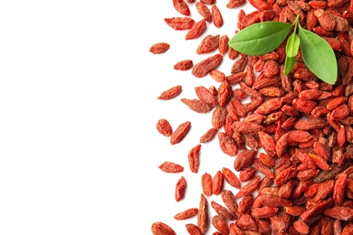 Photo of Pile of dried goji berries and leaves on white background, top view