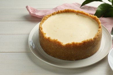 Photo of Tasty vegan tofu cheesecake on white wooden table. Space for text