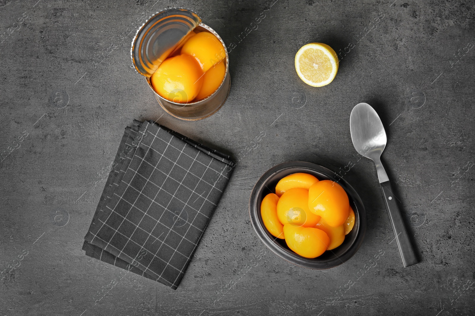 Photo of Flat lay composition with canned peaches on grey background