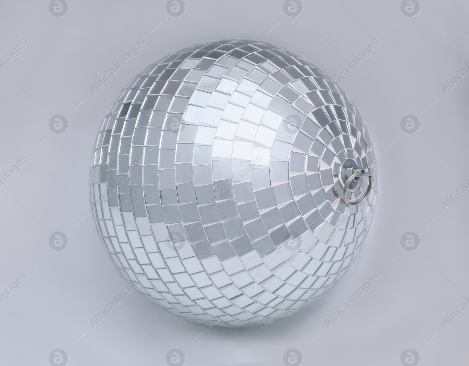 Photo of One shiny disco ball on light grey background