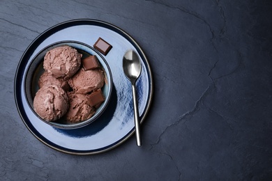Photo of Yummy chocolate ice cream served on black table, top view. Space for text