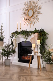 Photo of Stylish room interior with fireplace and beautiful Christmas decor