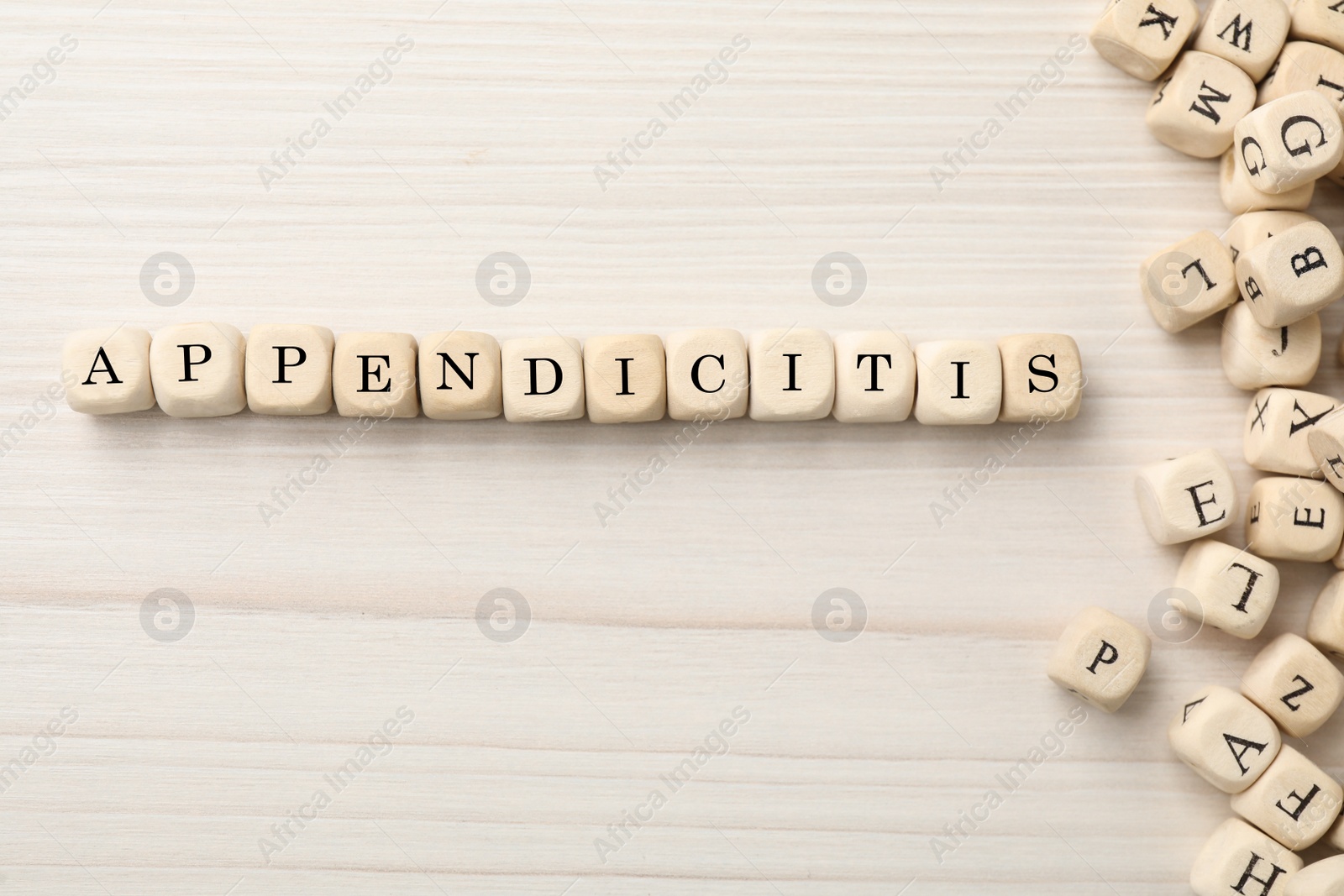 Photo of Word Appendicitis made of cubes with letters on white wooden background, flat lay. Space for text