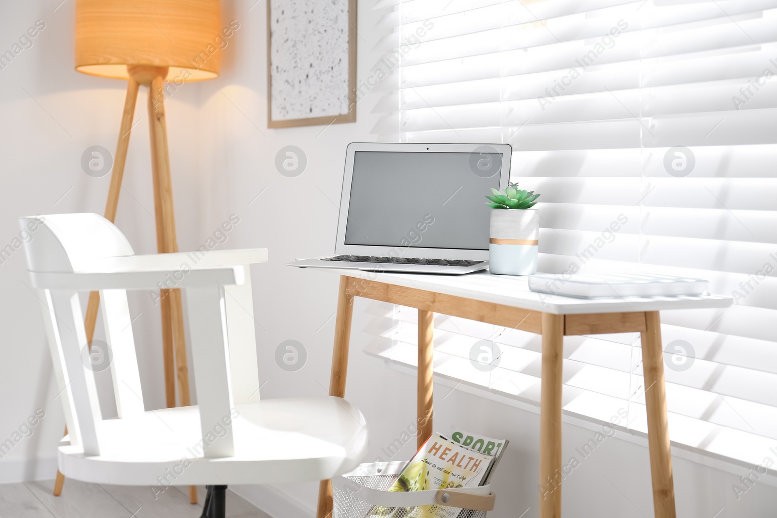 Photo of Comfortable workplace with laptop near window at home