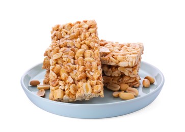Photo of Plate with tasty kozinaki bars and peanuts isolated on white