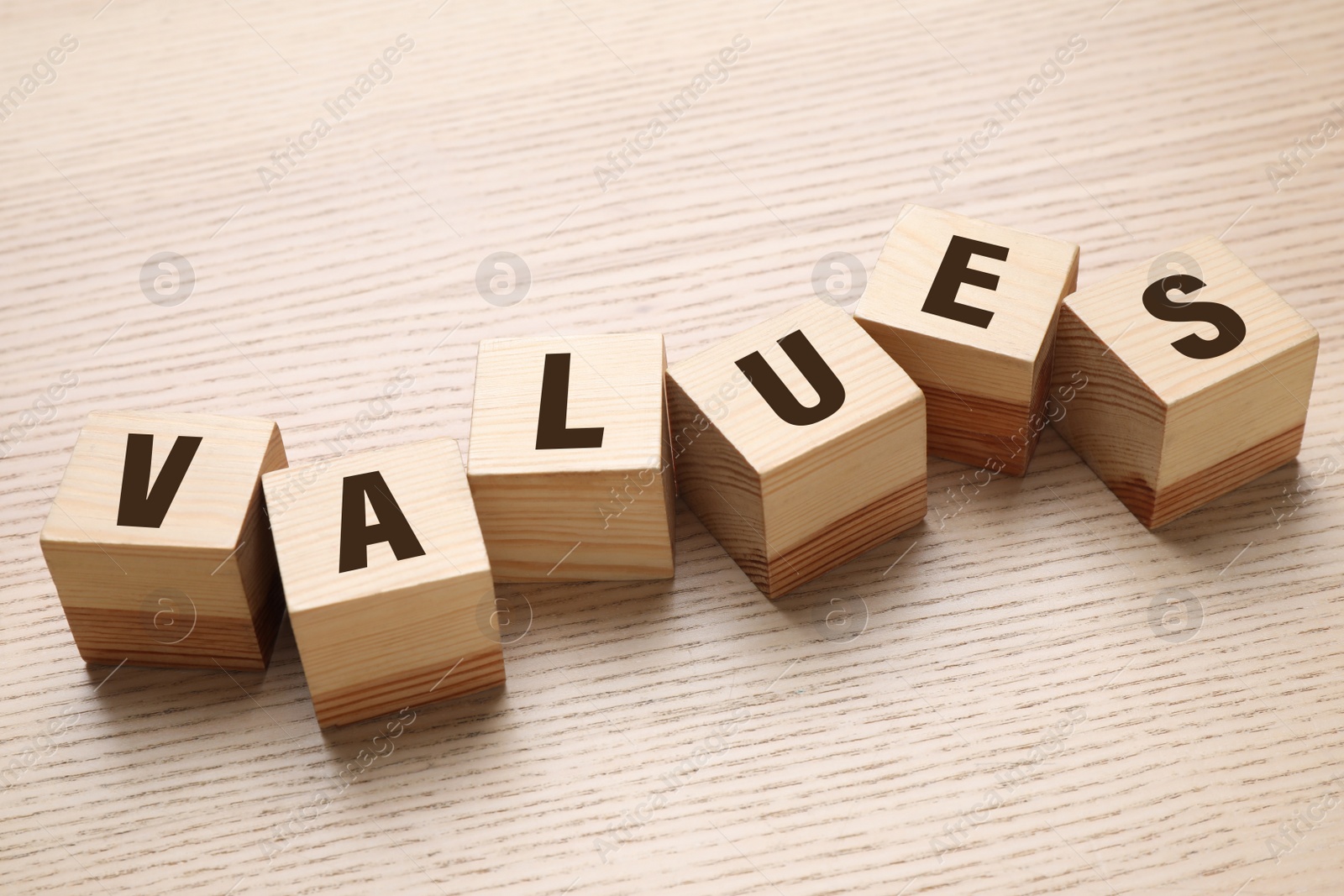 Photo of Cubes with word VALUES on wooden background