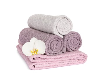 Photo of Clean soft towels with orchid isolated on white