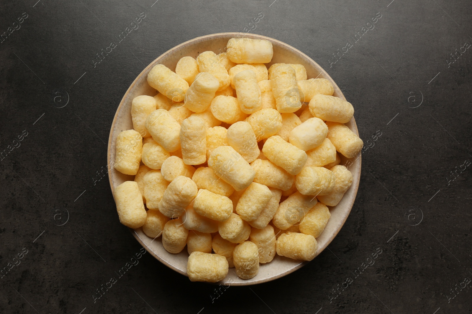 Photo of Plate of corn sticks on dark grey table, top view