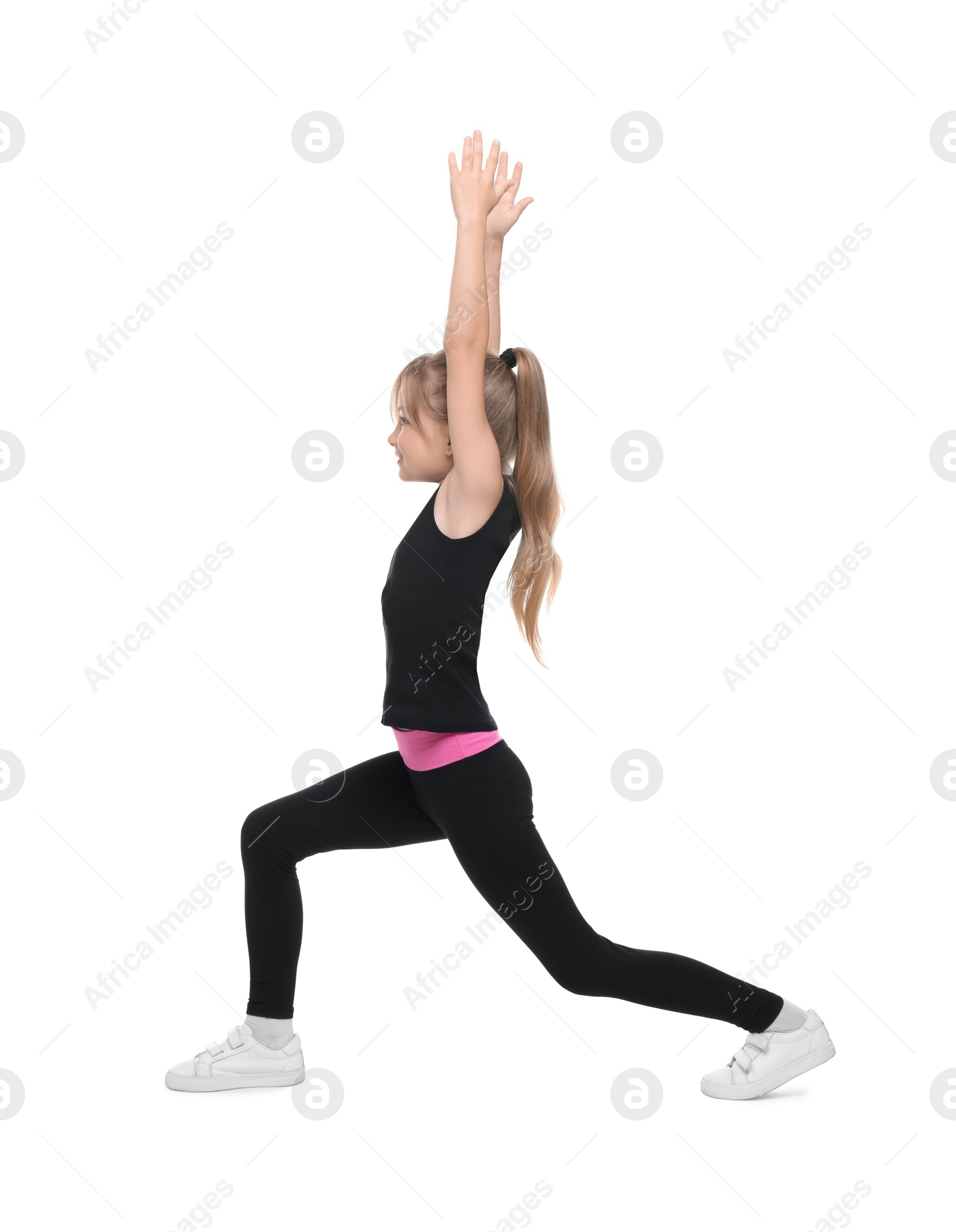 Photo of Little girl doing morning exercise on white background