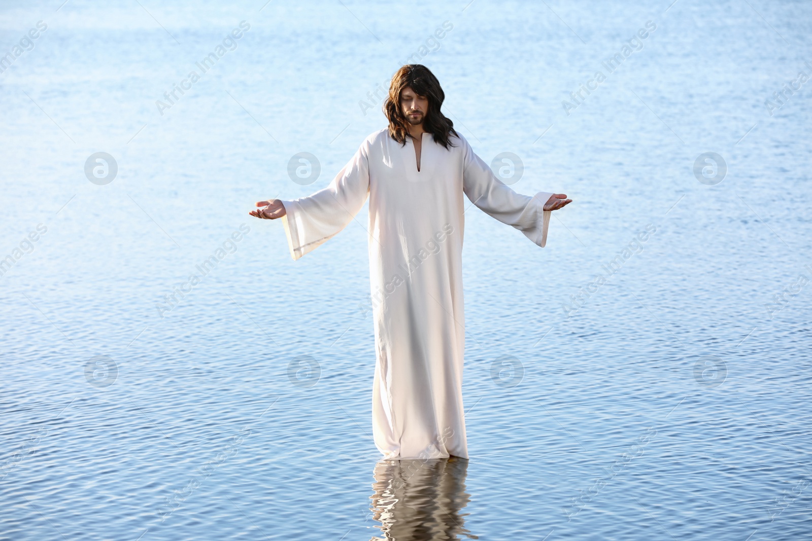 Photo of Jesus Christ in water lit by morning sun