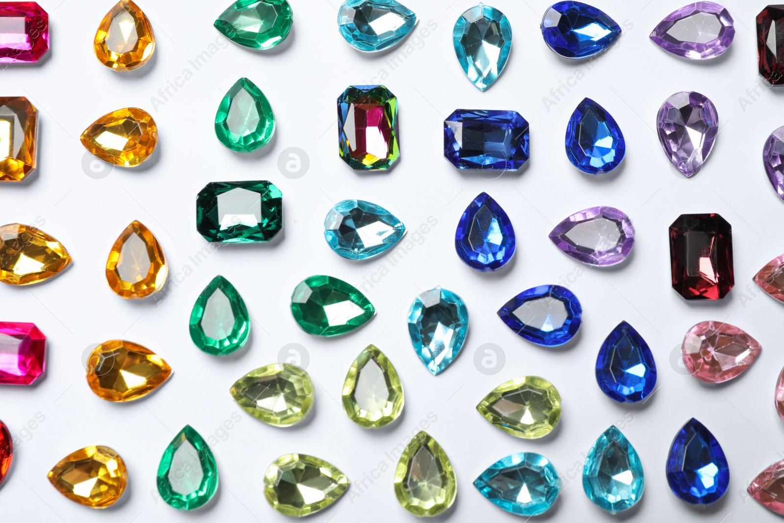 Photo of Different beautiful gemstones on white background, top view