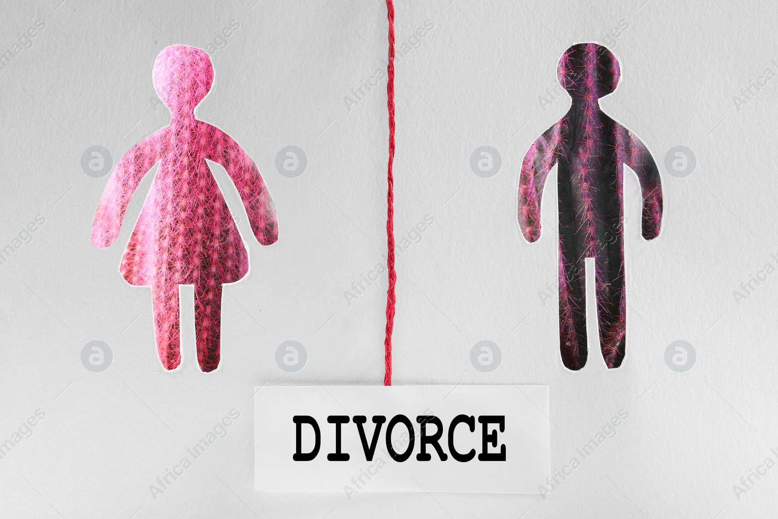 Photo of Word Divorce between man and woman silhouettes, view through holes in white paper