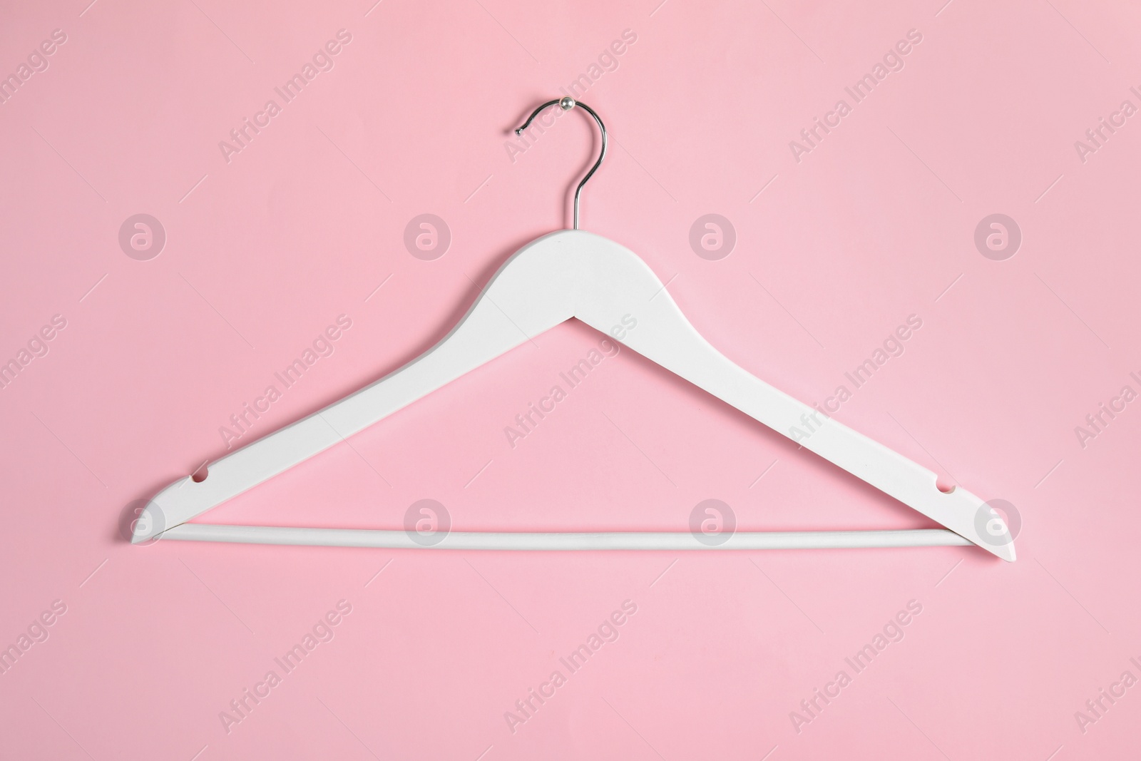 Photo of Empty clothes hanger on color background. Wardrobe accessory