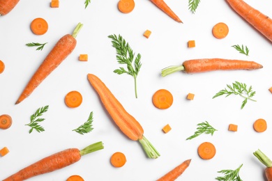 Tasty ripe carrots and leaves isolated on white, top view