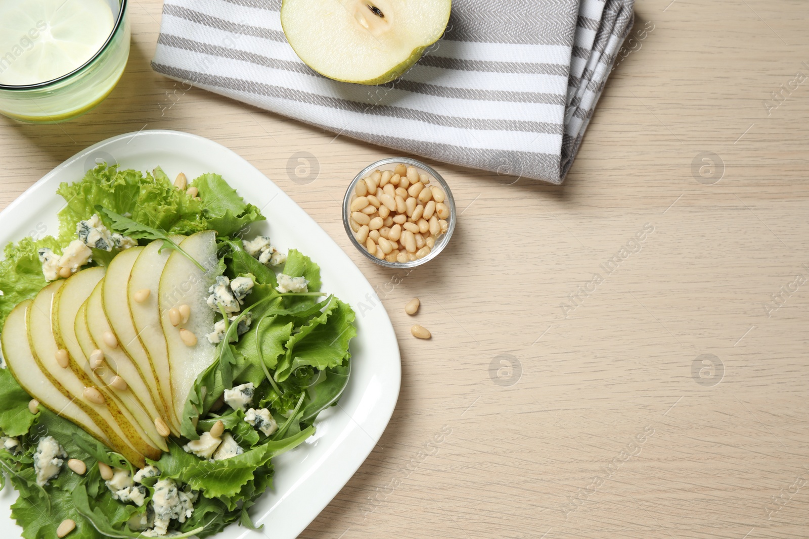 Photo of Fresh salad with pear served on wooden table, flat lay. Space for text