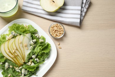 Fresh salad with pear served on wooden table, flat lay. Space for text