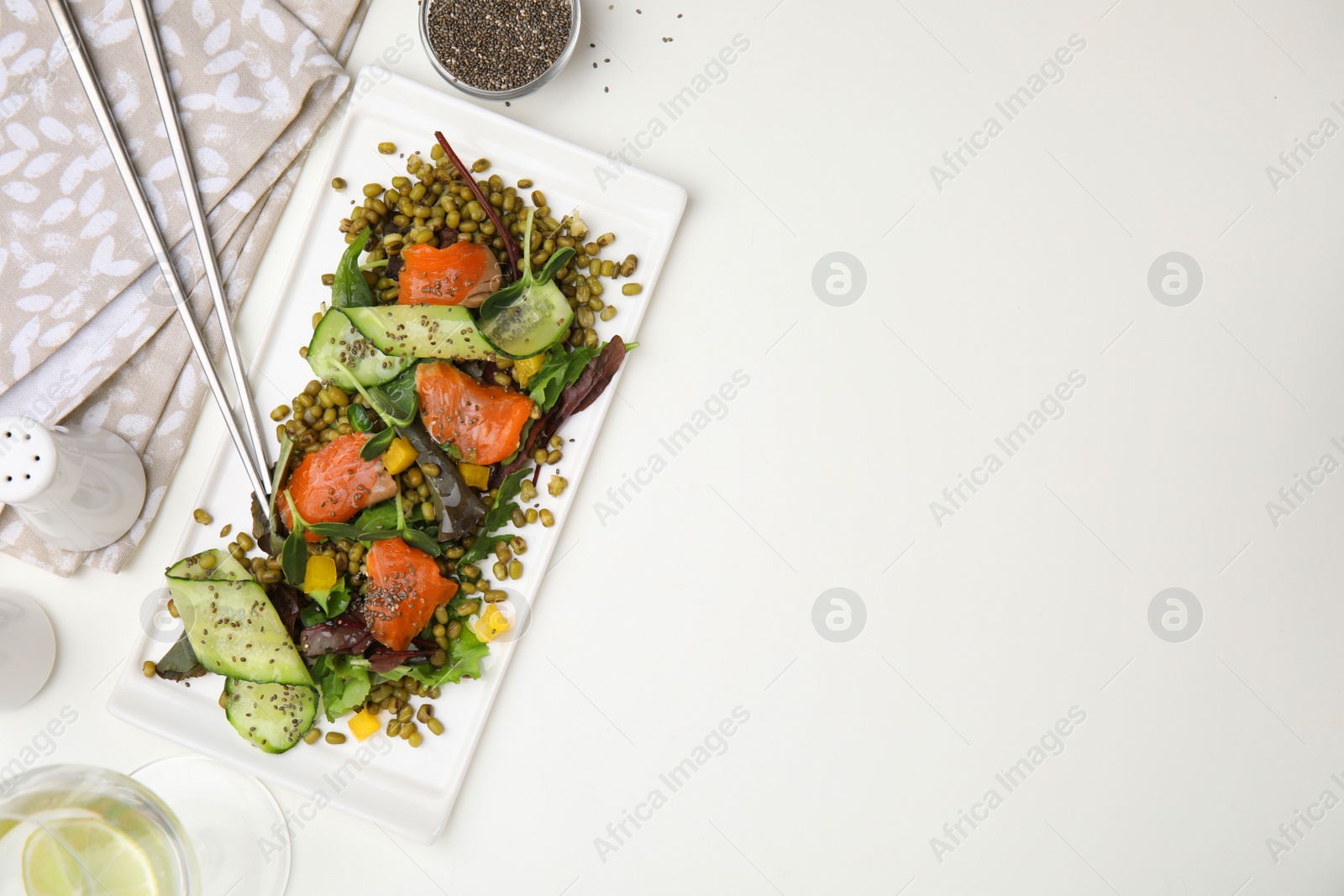 Photo of Plate of salad with mung beans on white table, flat lay. Space for text