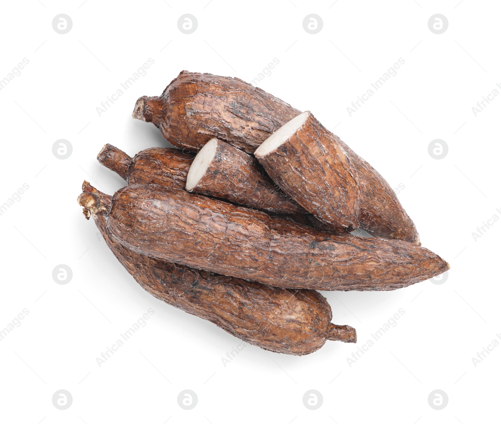 Photo of Whole and cut cassava roots isolated on white, top view