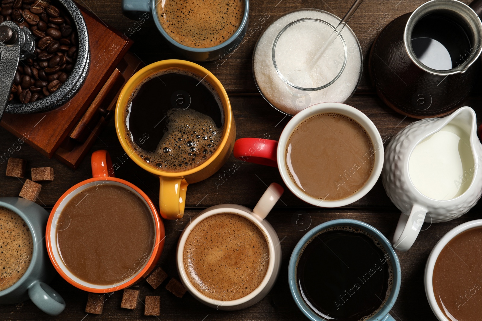 Photo of Cups of fresh aromatic coffee on wooden table, flat lay