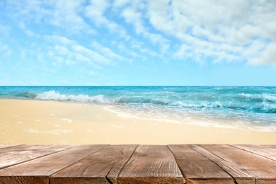 Image of Wooden surface on sandy beach near ocean