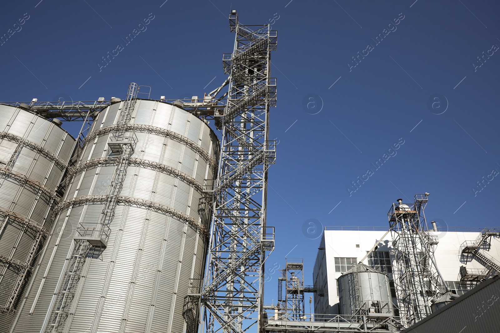 Photo of Modern granaries for storing cereal grains outdoors, low angle view