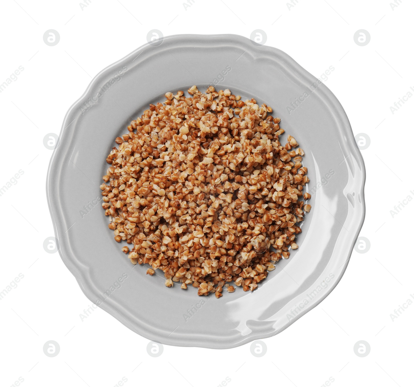 Photo of Plate with tasty buckwheat isolated on white, top view