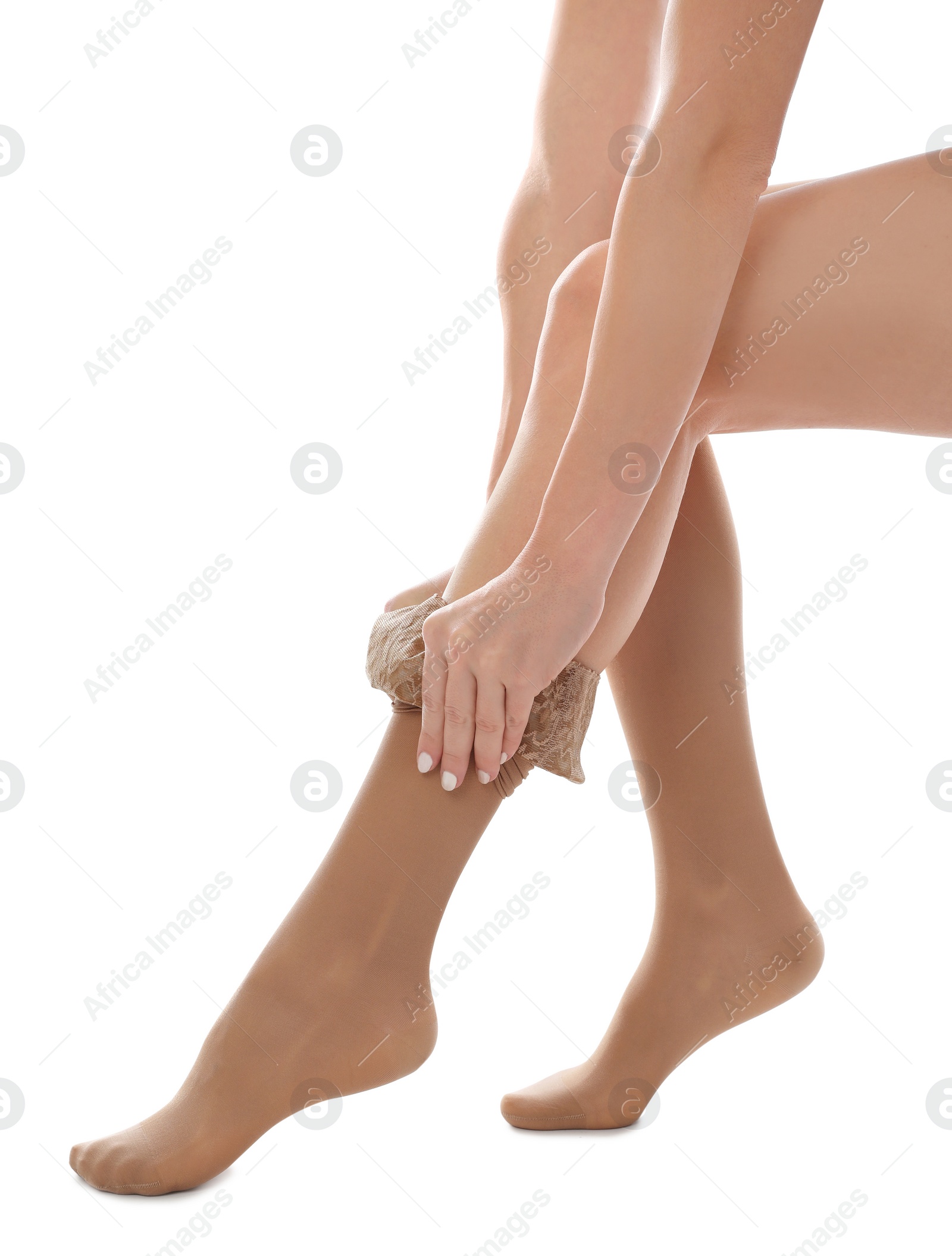 Photo of Woman putting on compression stocking against white background, closeup