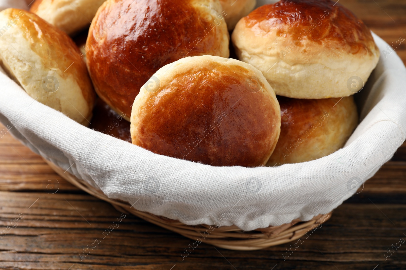 Photo of Tasty scones prepared on soda water on wooden table, closeup